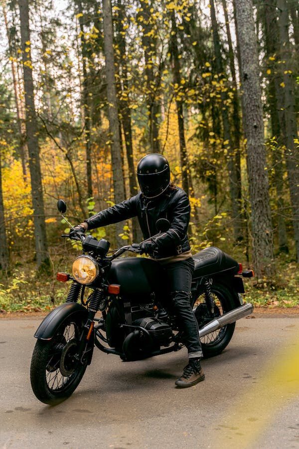 man wearing helmet and protection riding motorcycle